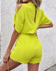 Summer 2025 elegance: cold-shoulder jumpsuit with a high waist.