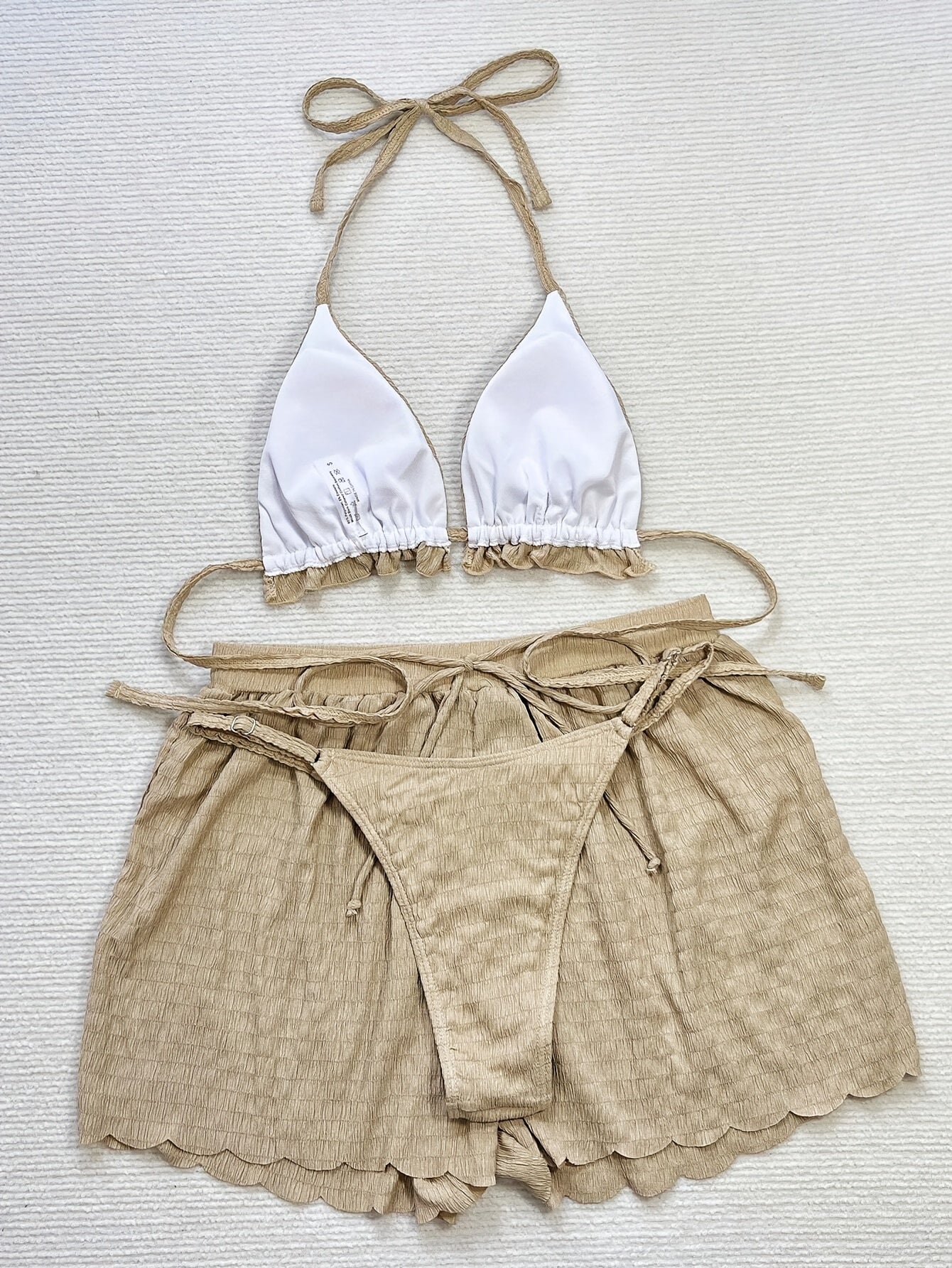 3-piece bikini with ruffles, floral embroidery, and mesh cover-up shorts.