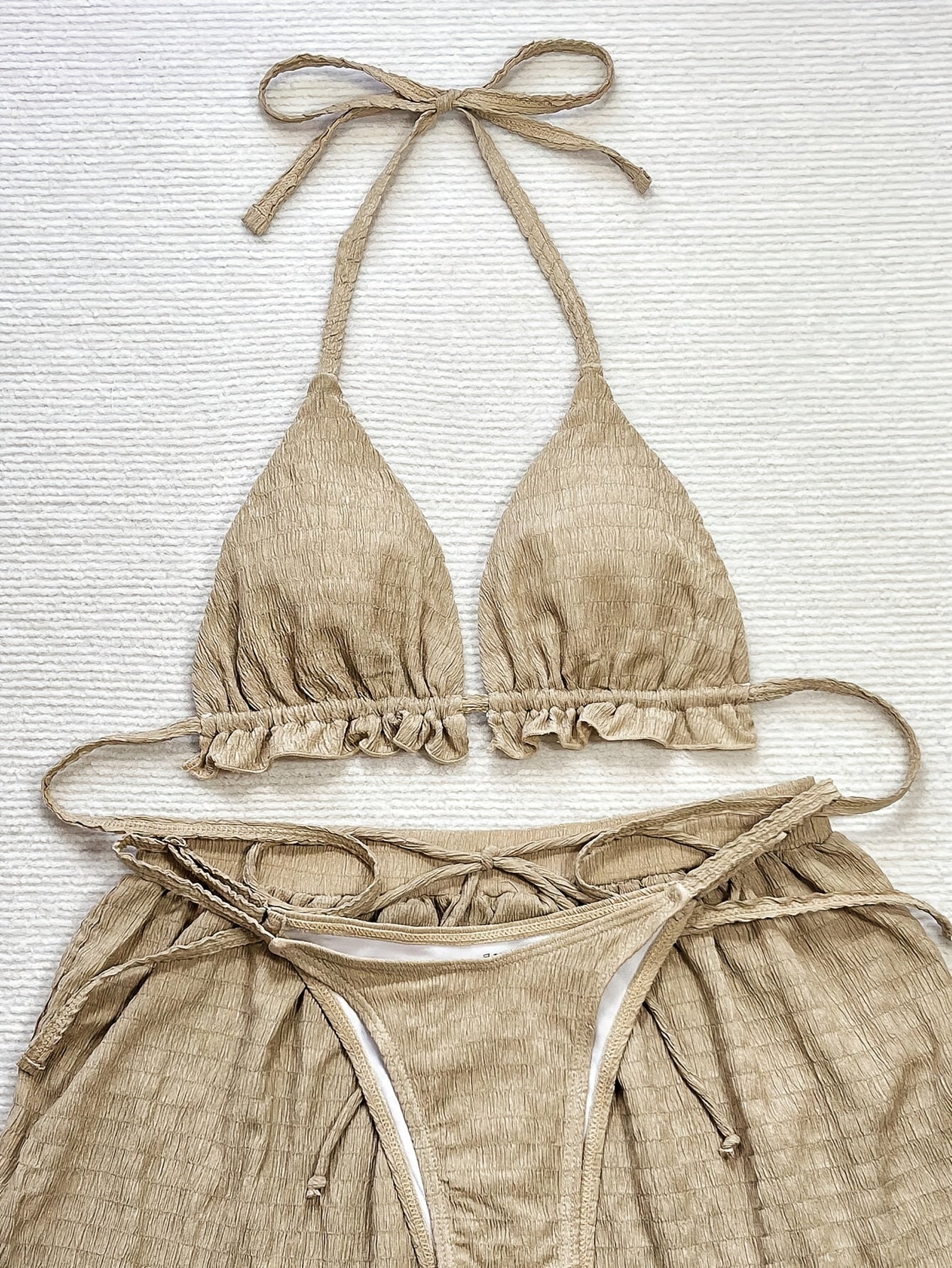 3-piece bikini with ruffles, floral embroidery, and mesh cover-up shorts.