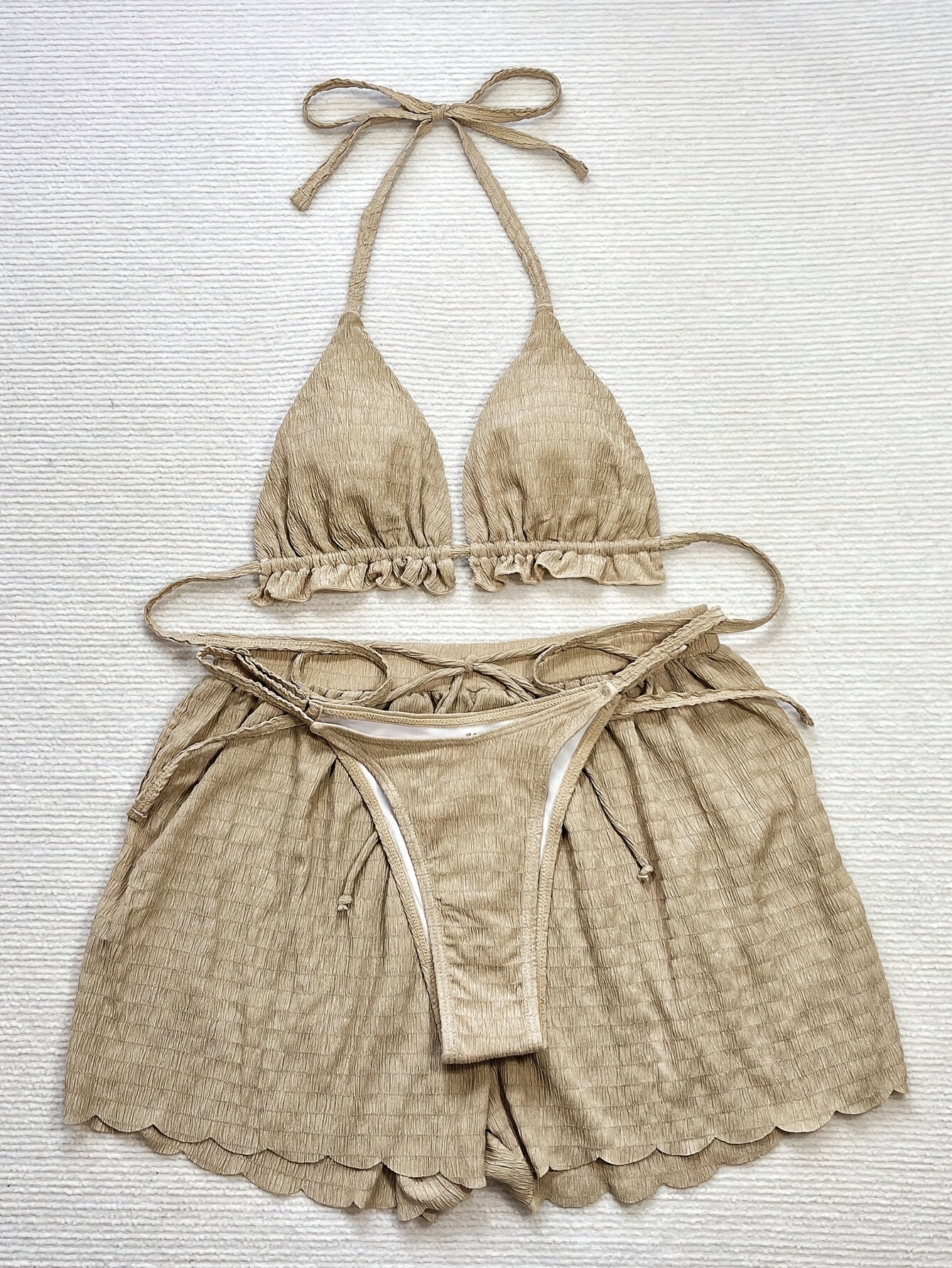 3-piece bikini with ruffles, floral embroidery, and mesh cover-up shorts.