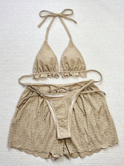 3-piece bikini with ruffles, floral embroidery, and mesh cover-up shorts.