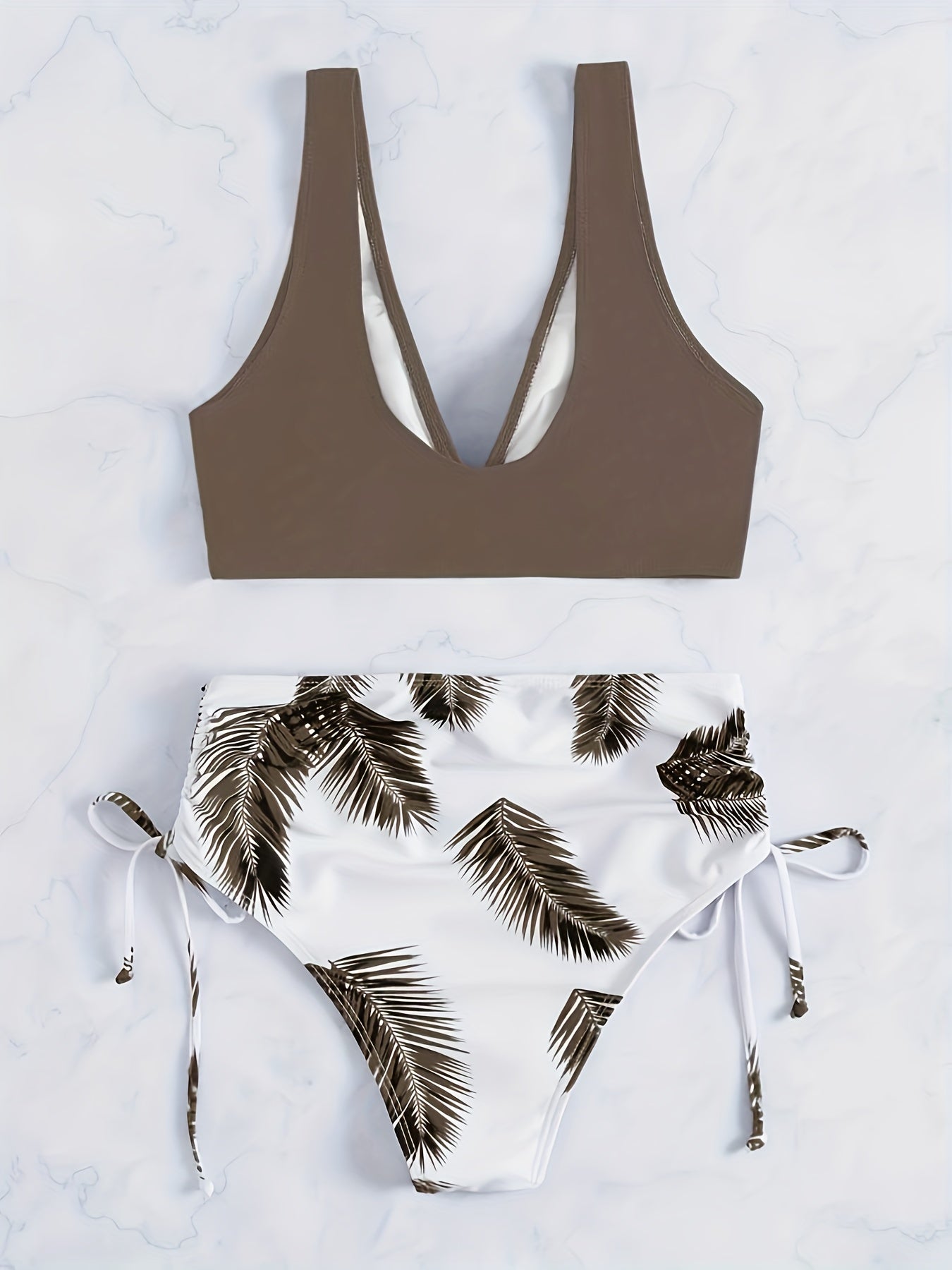 Leaf print color-block bikini set with tie-front top and side-cut bottom.