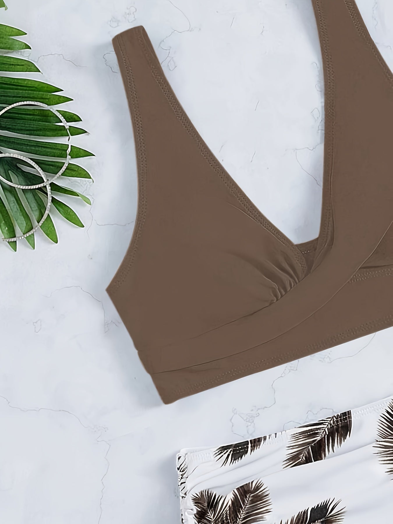 Leaf print color-block bikini set with tie-front top and side-cut bottom.
